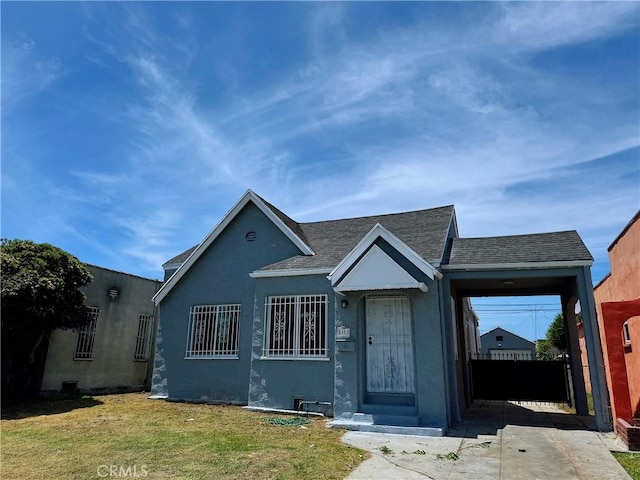 6121 S Wilton Pl, Los Angeles, CA 90047 - view of front facade with stucco siding and roof with shingles