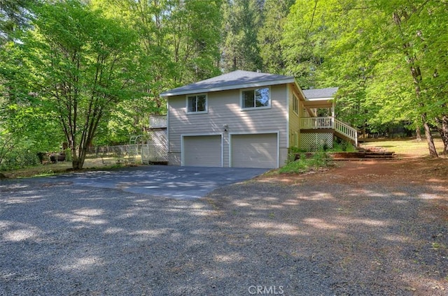 6125 Desabla Ln, Magalia, CA 95954 - view of front of house featuring stairs, asphalt driveway, an attached garage, and a wooded view