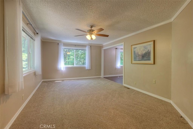 6125 Desabla Ln, Magalia, CA 95954 - spare room featuring a textured ceiling, crown molding, carpet, a ceiling fan, and baseboards