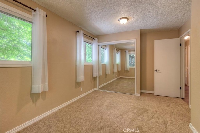 6125 Desabla Ln, Magalia, CA 95954 - unfurnished bedroom with a textured ceiling, carpet floors, a closet, and baseboards