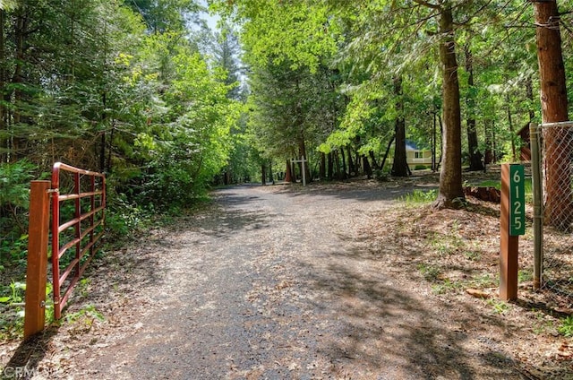 6125 Desabla Ln, Magalia, CA 95954 - view of dirt / gravel road with a gated entry and a forest view