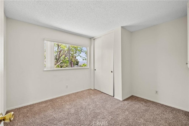 19627 Goldstream Way, Newhall, CA 91321 - unfurnished bedroom with carpet, a textured ceiling, a closet, and baseboards