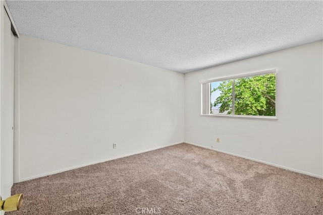 19627 Goldstream Way, Newhall, CA 91321 - spare room featuring carpet floors, a textured ceiling, and baseboards