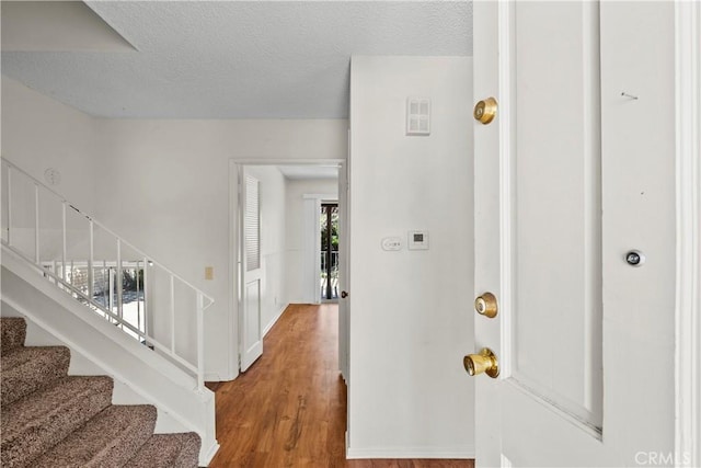 19627 Goldstream Way, Newhall, CA 91321 - entrance foyer with stairs, wood finished floors, and a textured ceiling