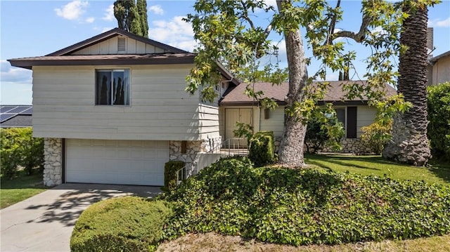 19627 Goldstream Way, Newhall, CA 91321 - view of front of house featuring stone siding, a garage, and concrete driveway