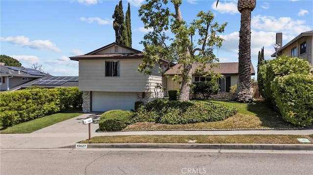 19627 Goldstream Way, Newhall, CA 91321 - split level home with stone siding, an attached garage, and concrete driveway