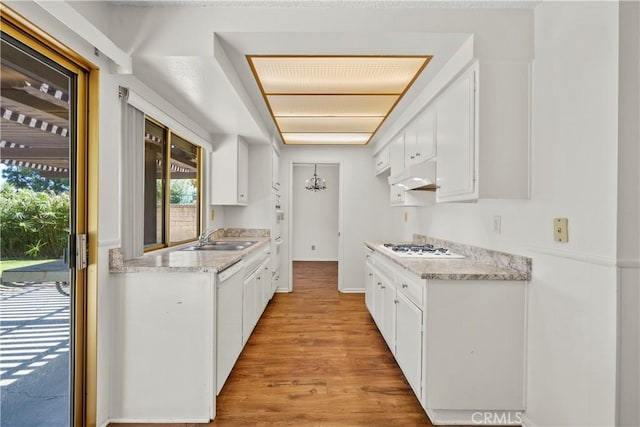 19627 Goldstream Way, Newhall, CA 91321 - kitchen with under cabinet range hood, a sink, light wood-type flooring, and white cabinets
