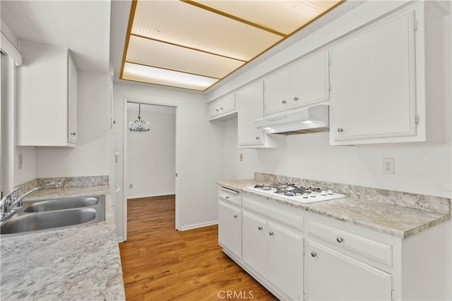 19627 Goldstream Way, Newhall, CA 91321 - kitchen featuring a sink, under cabinet range hood, white gas cooktop, light wood-style flooring, and white cabinets