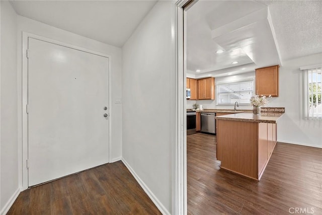 1418 E Wilshire Ave, Fullerton, CA 92831 - kitchen featuring stainless steel appliances, a peninsula, dark wood-style floors, a sink, and recessed lighting