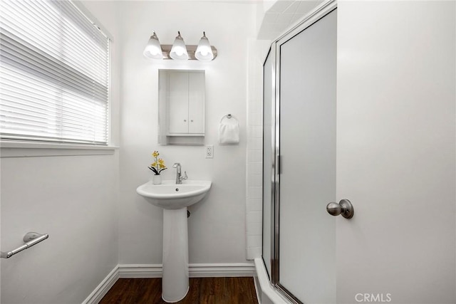 1418 E Wilshire Ave, Fullerton, CA 92831 - bathroom featuring wood finished floors, a shower stall, baseboards, and a sink