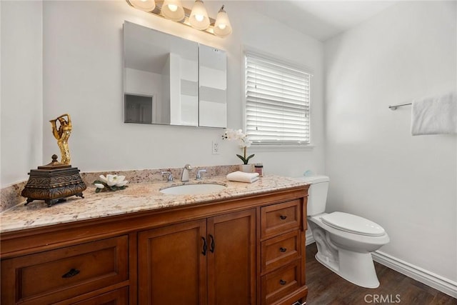 1418 E Wilshire Ave, Fullerton, CA 92831 - bathroom with vanity, toilet, wood finished floors, and baseboards