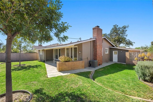 1418 E Wilshire Ave, Fullerton, CA 92831 - rear view of property featuring stucco siding, cooling unit, a chimney, and a patio