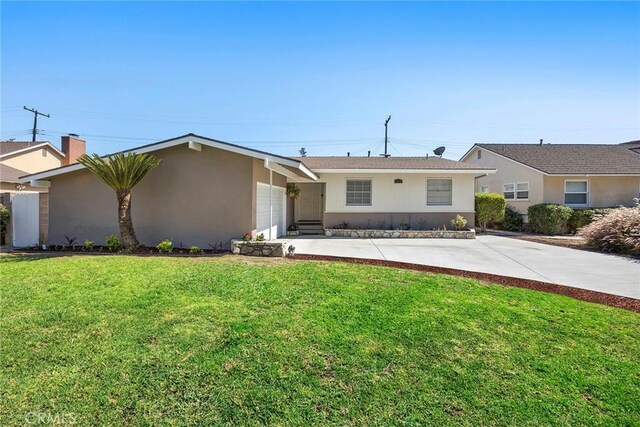 1418 E Wilshire Ave, Fullerton, CA 92831 - single story home featuring a front yard, an attached garage, and stucco siding
