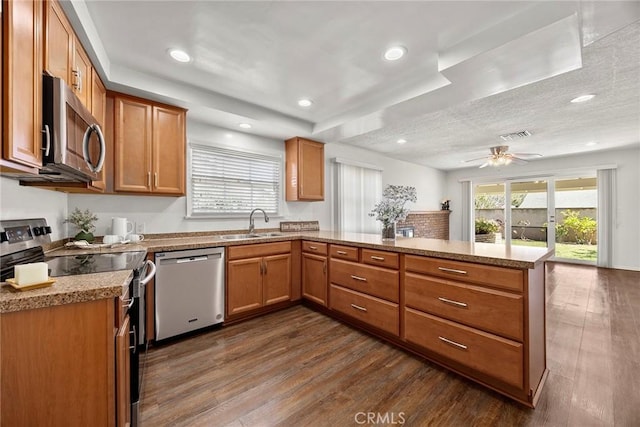 1418 E Wilshire Ave, Fullerton, CA 92831 - kitchen featuring stainless steel appliances, a peninsula, dark wood-type flooring, a sink, and ceiling fan