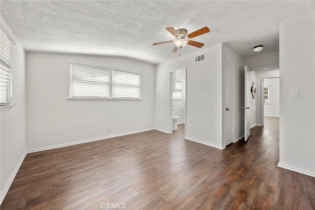 1418 E Wilshire Ave, Fullerton, CA 92831 - empty room with ceiling fan, dark wood-type flooring, plenty of natural light, baseboards, and a textured ceiling