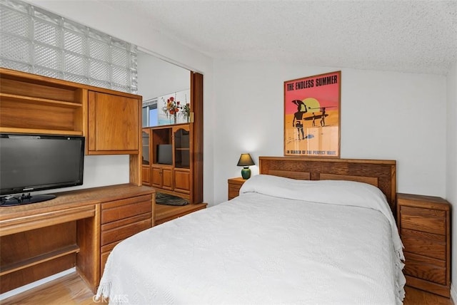 17152 Pacific Coast Unit 19, Huntington Beach, CA 92649 - bedroom with a textured ceiling and light wood finished floors