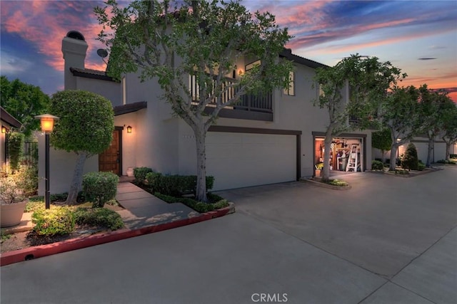 2209 E Badillo St, Covina, CA 91724 - view of front of home with a balcony, stucco siding, an attached garage, concrete driveway, and a chimney