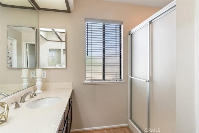 2209 E Badillo St, Covina, CA 91724 - bathroom featuring a stall shower, vanity, and wood finished floors