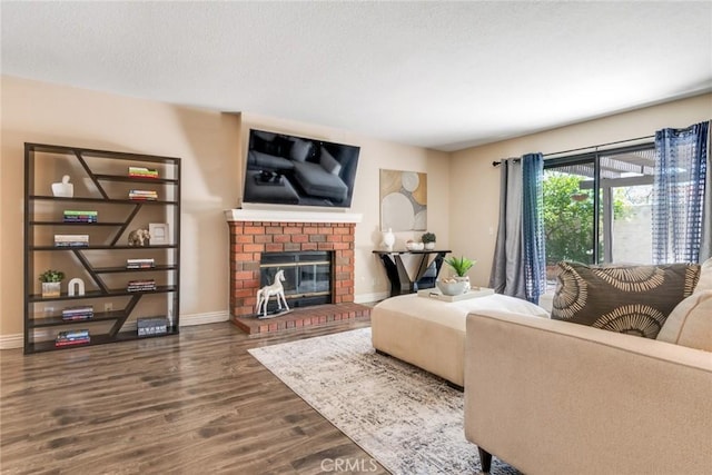 2209 E Badillo St, Covina, CA 91724 - living room featuring wood finished floors, a brick fireplace, baseboards, and a textured ceiling