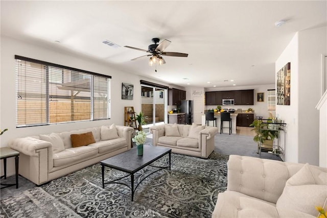 4337 Rima Dr, Fontana, CA 92336 - living room featuring a ceiling fan, recessed lighting, and light colored carpet
