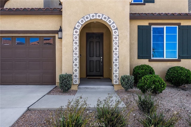 4337 Rima Dr, Fontana, CA 92336 - entrance to property featuring stucco siding, a garage, and concrete driveway