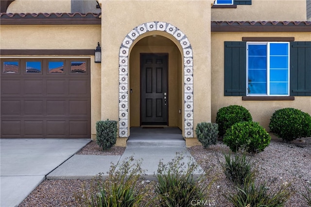 4337 Rima Dr, Fontana, CA 92336 - property entrance with stucco siding, a garage, and concrete driveway