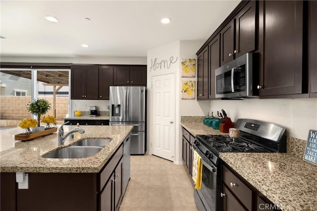 4337 Rima Dr, Fontana, CA 92336 - kitchen featuring stainless steel appliances, a sink, dark brown cabinets, light stone countertops, and recessed lighting