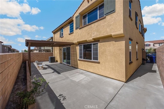 4337 Rima Dr, Fontana, CA 92336 - back of property with stucco siding, a patio area, a fenced backyard, and central air condition unit