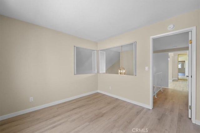 19924 Mildred Ave, Torrance, CA 90503 - unfurnished room with wood finished floors, a chandelier, baseboards, and a smoke detector