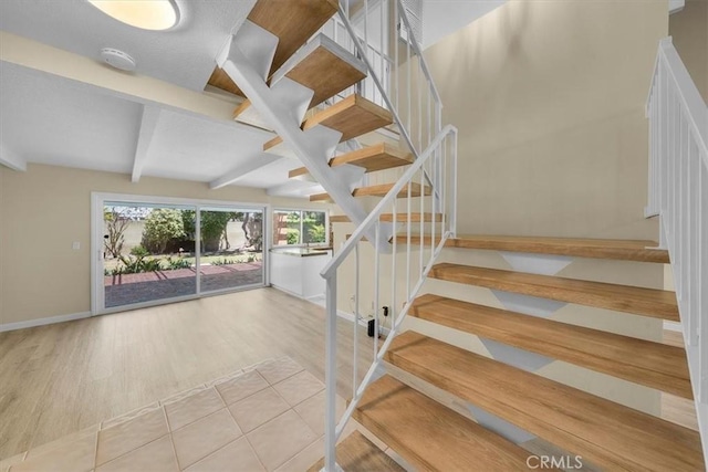 19924 Mildred Ave, Torrance, CA 90503 - staircase featuring baseboards, beam ceiling, and wood finished floors