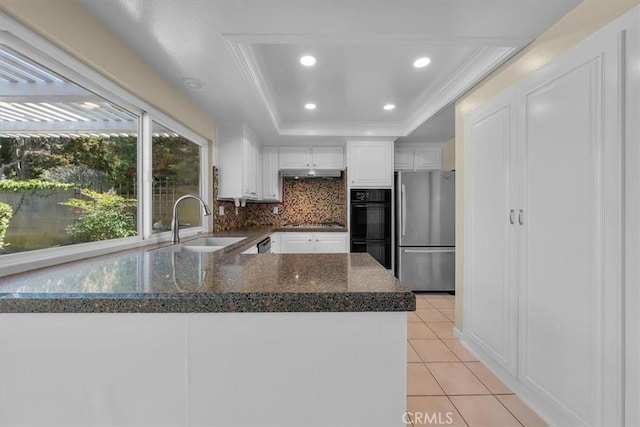 19924 Mildred Ave, Torrance, CA 90503 - kitchen with stainless steel appliances, a tray ceiling, white cabinetry, backsplash, and a peninsula
