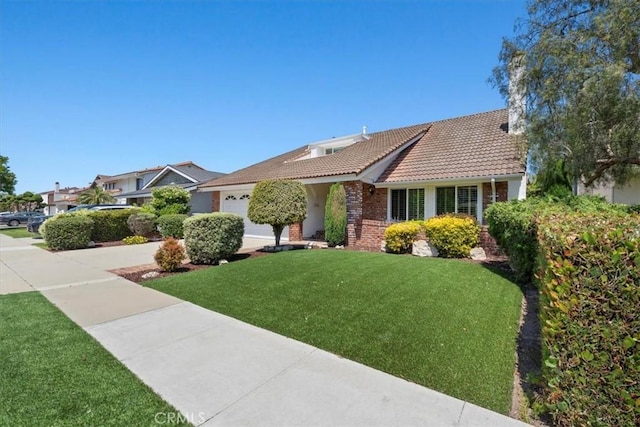19924 Mildred Ave, Torrance, CA 90503 - view of front facade with an attached garage, a front lawn, a tile roof, concrete driveway, and brick siding