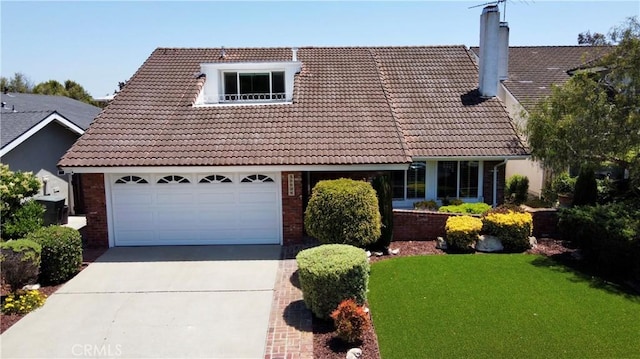 19924 Mildred Ave, Torrance, CA 90503 - view of front of house with a tile roof, driveway, a chimney, and brick siding