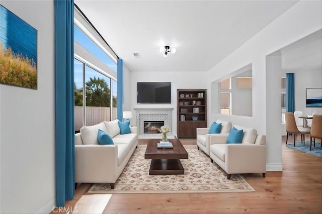 44779 Corte Sanchez, Temecula, CA 92592 - living area featuring wood finished floors, a tiled fireplace, built in features, and baseboards