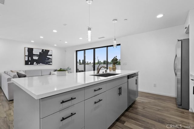 41361/2 Normal Ave Unit 1/2, Los Angeles, CA 90029 - kitchen featuring a sink, appliances with stainless steel finishes, dark wood finished floors, recessed lighting, and a center island with sink