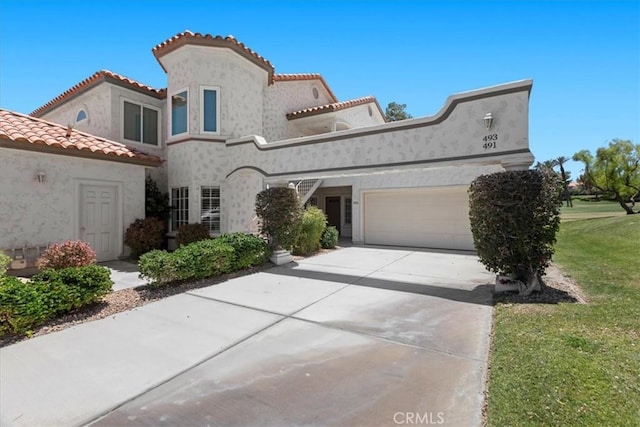491 Desert Falls Dr N, Palm Desert, CA 92211 - view of front of house featuring a garage, stucco siding, a tile roof, and concrete driveway