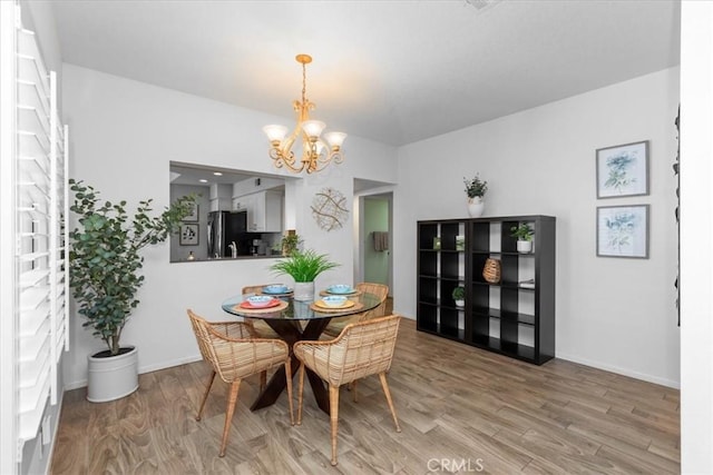 491 Desert Falls Dr N, Palm Desert, CA 92211 - dining space featuring a chandelier, light wood finished floors, and baseboards