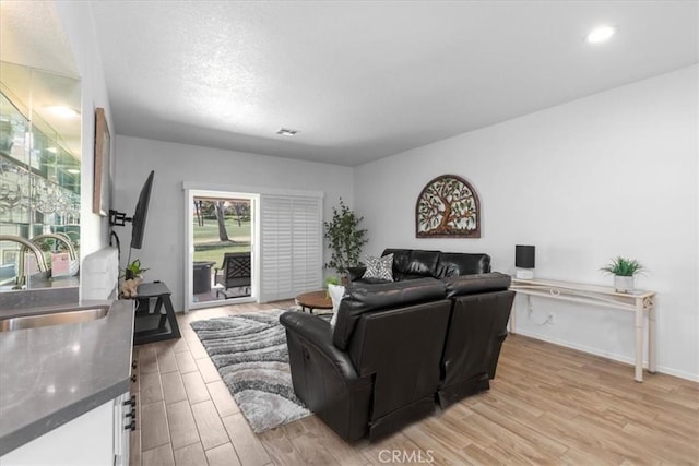 491 Desert Falls Dr N, Palm Desert, CA 92211 - living room featuring light wood-style floors, baseboards, and recessed lighting