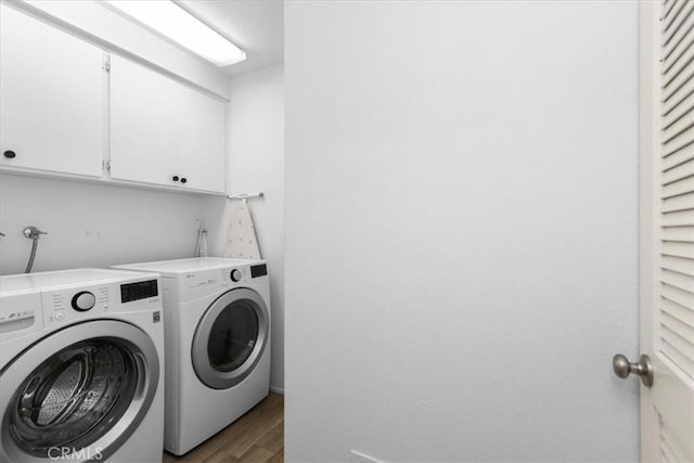 491 Desert Falls Dr N, Palm Desert, CA 92211 - laundry room featuring washer and clothes dryer, wood finished floors, and cabinet space