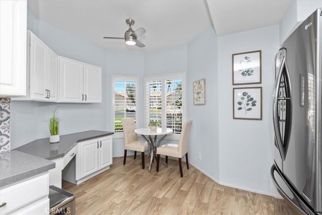 491 Desert Falls Dr N, Palm Desert, CA 92211 - kitchen with freestanding refrigerator, a ceiling fan, white cabinets, light wood-style floors, and dark countertops