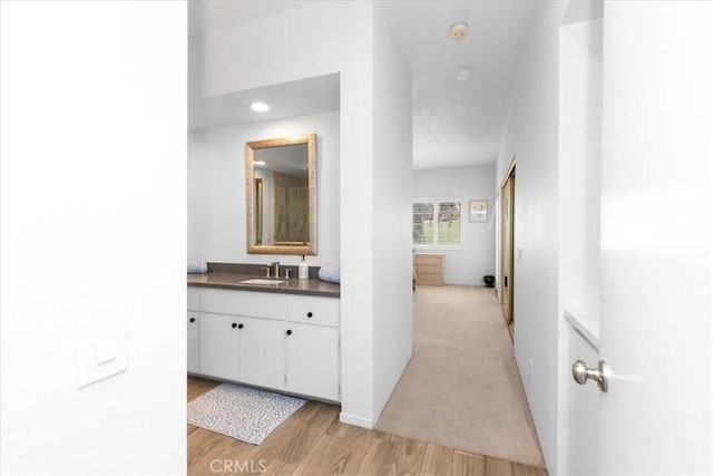 491 Desert Falls Dr N, Palm Desert, CA 92211 - corridor with a sink, light wood-type flooring, recessed lighting, and baseboards
