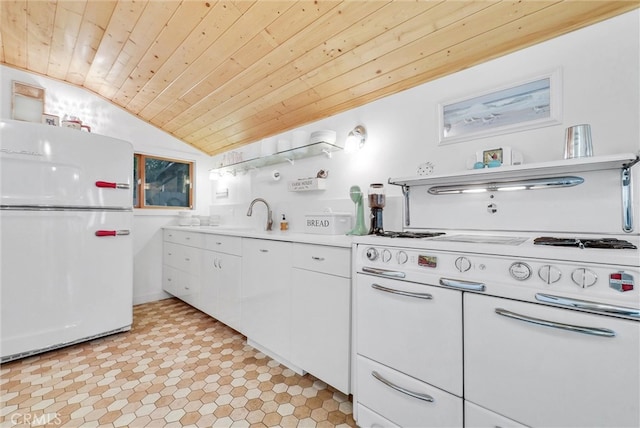 319 W 6th St, Claremont, CA 91711 - kitchen with freestanding refrigerator, wooden ceiling, vaulted ceiling, a sink, and white cabinets