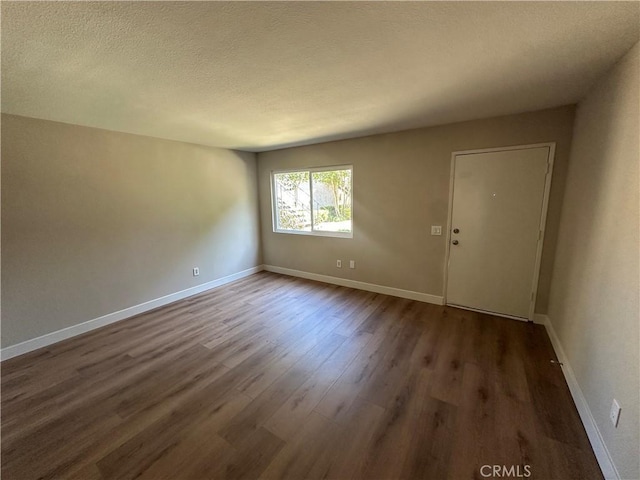 2394 Gonzaga Ln, Riverside, CA 92507 - empty room featuring dark wood-type flooring and a textured ceiling