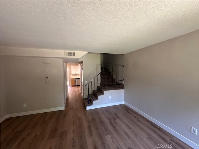 2394 Gonzaga Ln, Riverside, CA 92507 - unfurnished living room with stairway, dark wood finished floors, and a textured ceiling
