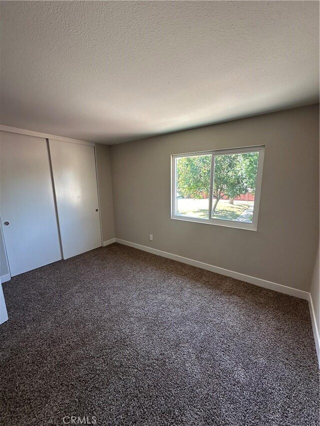 2394 Gonzaga Ln, Riverside, CA 92507 - empty room with a textured ceiling and carpet floors