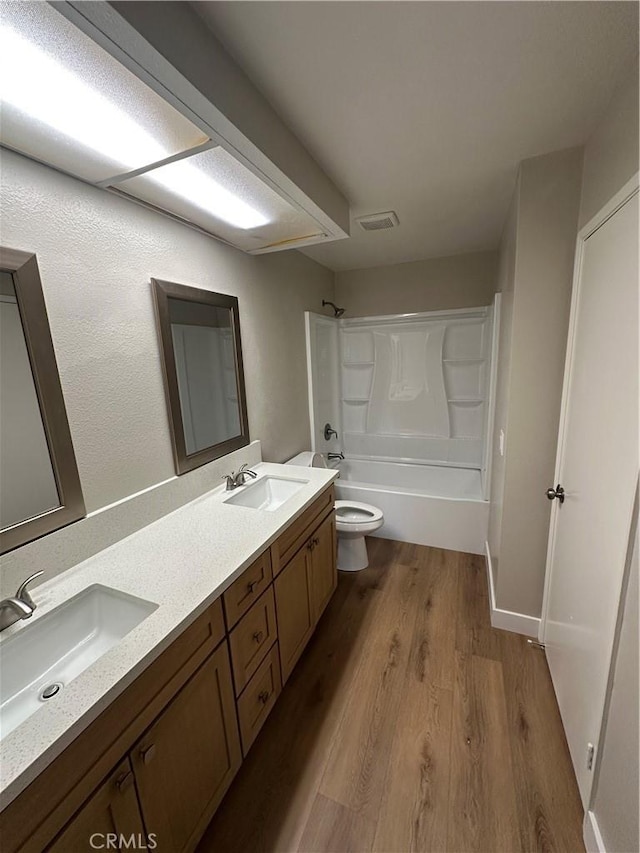 2394 Gonzaga Ln, Riverside, CA 92507 - full bathroom featuring wood finished floors, double vanity, and shower / bathtub combination