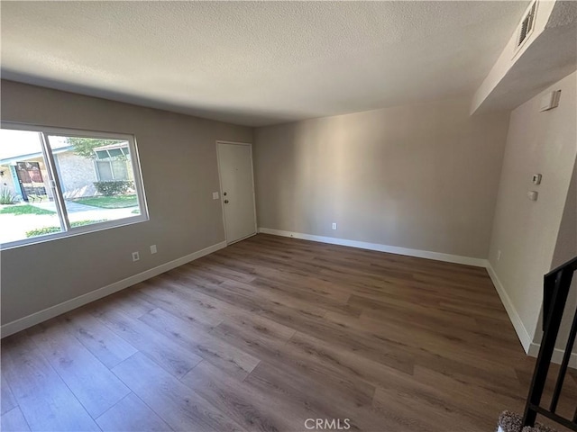 2394 Gonzaga Ln, Riverside, CA 92507 - unfurnished room featuring wood finished floors and a textured ceiling
