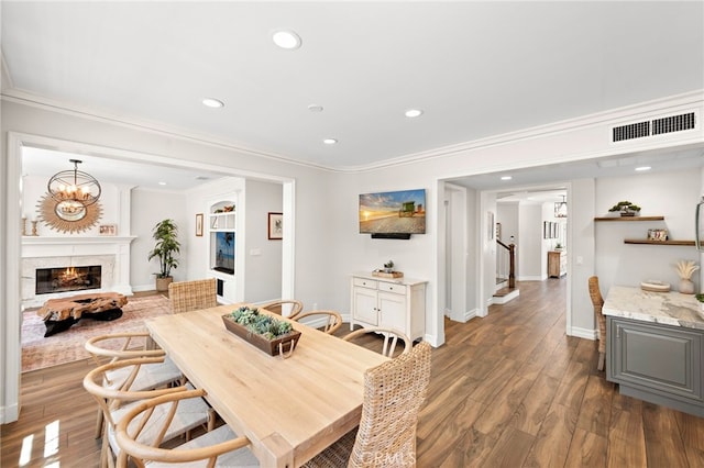 11 Markham Ln, Ladera Ranch, CA 92694 - dining room with wood finished floors, ornamental molding, recessed lighting, and a lit fireplace