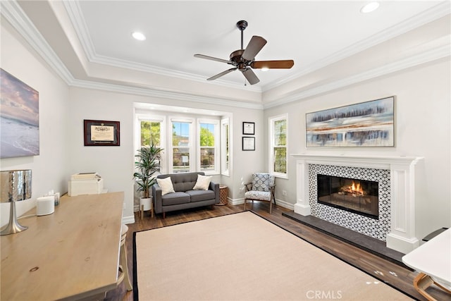 11 Markham Ln, Ladera Ranch, CA 92694 - living room featuring dark wood-style floors, a tiled fireplace, a ceiling fan, ornamental molding, and recessed lighting