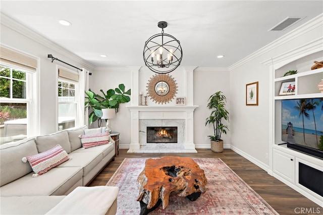 11 Markham Ln, Ladera Ranch, CA 92694 - living area with a chandelier, dark wood-type flooring, recessed lighting, a fireplace, and crown molding